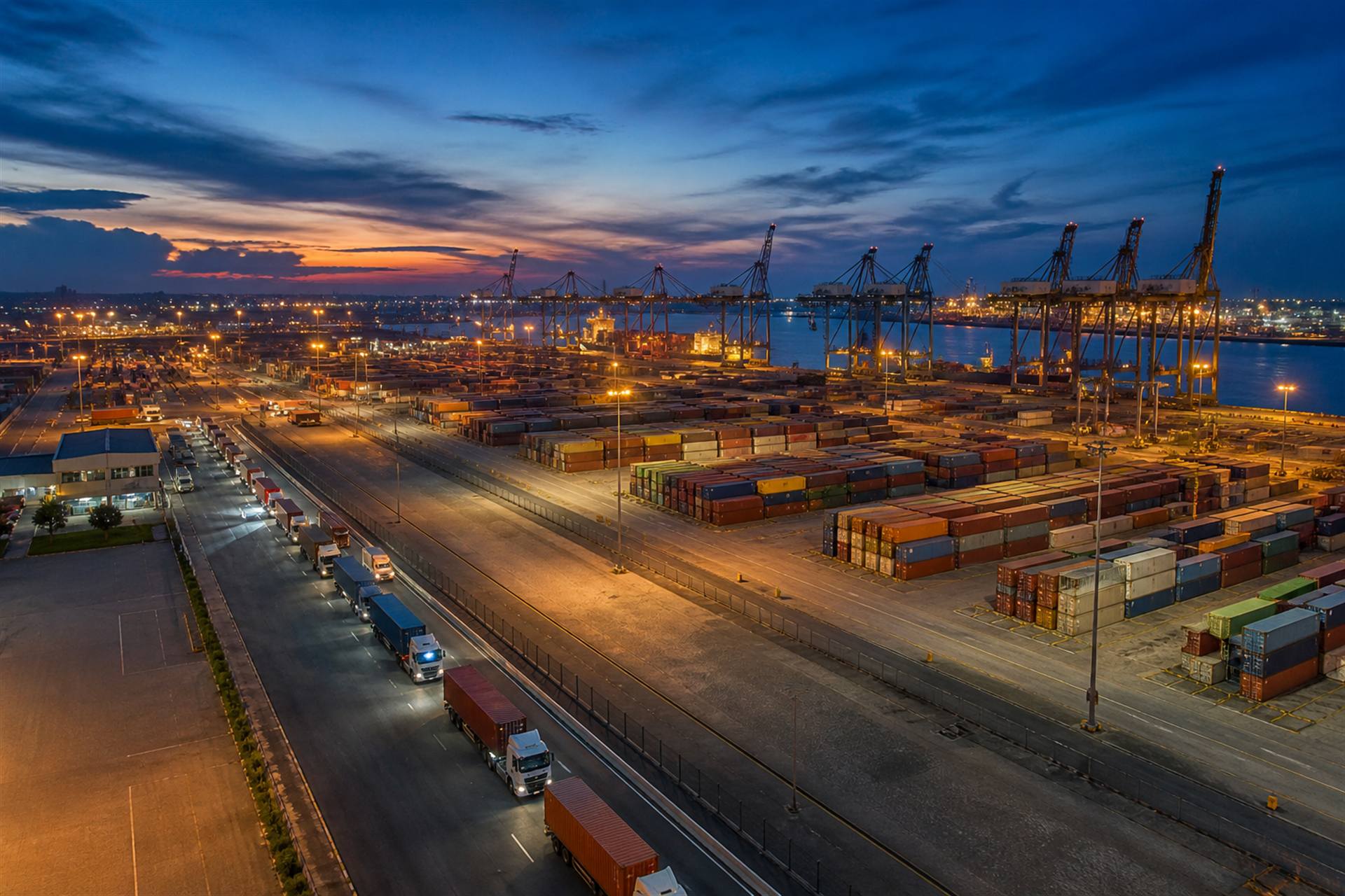 Container terminal and freight yard lit up at dusk